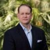 AmeriVet CEO Thomas Thill, pictured against a background of tropical trees