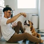 Boy sharing food with dog