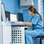 veterinarian using computer at desk