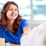 Happy veterinary candidate shaking hands with someone off camera