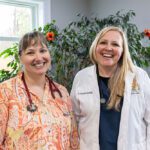 two smiling veterinarians