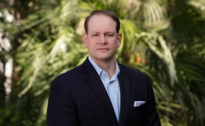 AmeriVet CEO Thomas Thill, pictured against a background of tropical trees