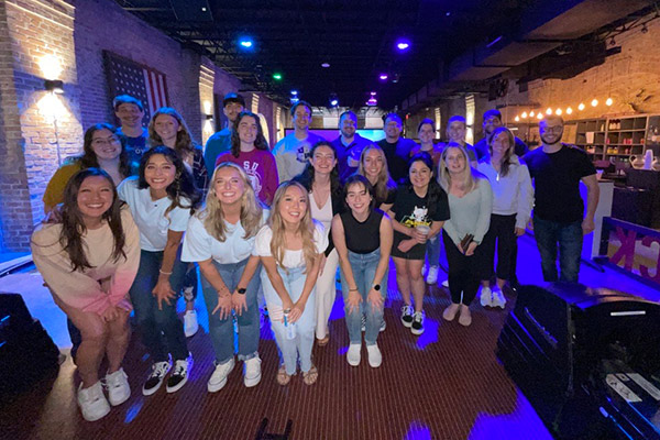 group of cheerful veterinary students at a bowling social event