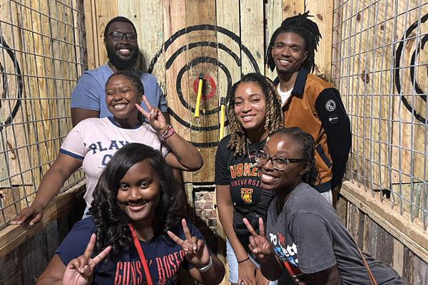 group of veterinary students at an axe-throwing range