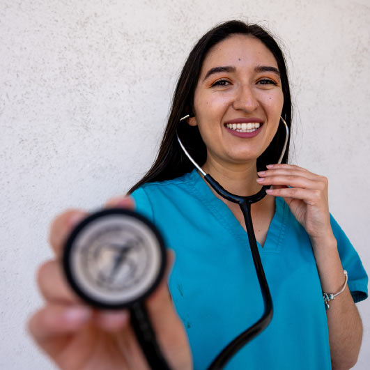 veterinary team member holding a stethoscope up to the camera